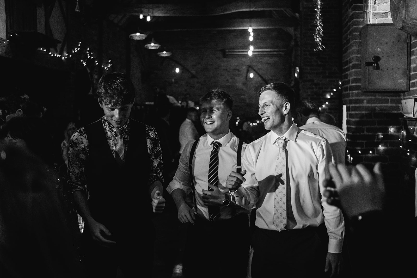 Wedding guests enjoying a band and singing, black and white - taken at Donnington Park Farmhouse