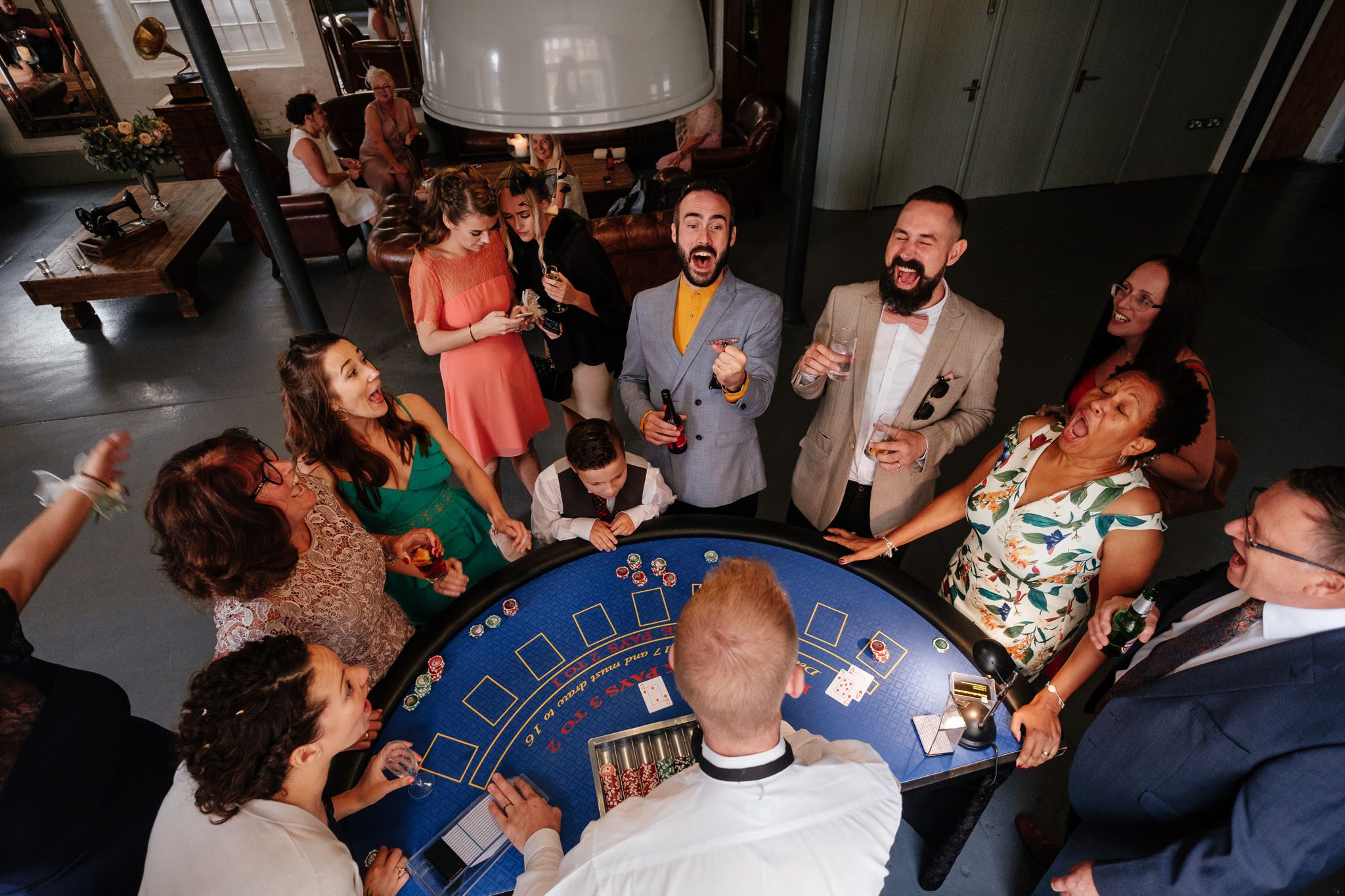 Wedding guests enjoying a card game at The West Mill in Derbyshire